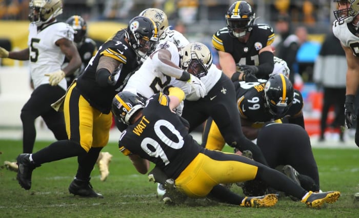 New Orleans Saints Jordan Howard (28) gets wrapped up for a tackle in the backfield by Pittsburgh Steelers T.J. Watt (90).